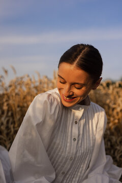 Female model in blouse feeling happy 