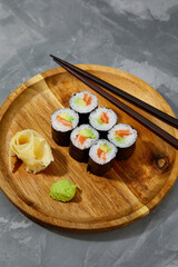 Set of tuna sushi rolls on black desk background