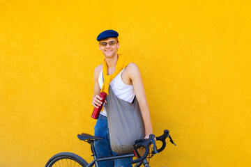 man standing on the street with a bicycle
