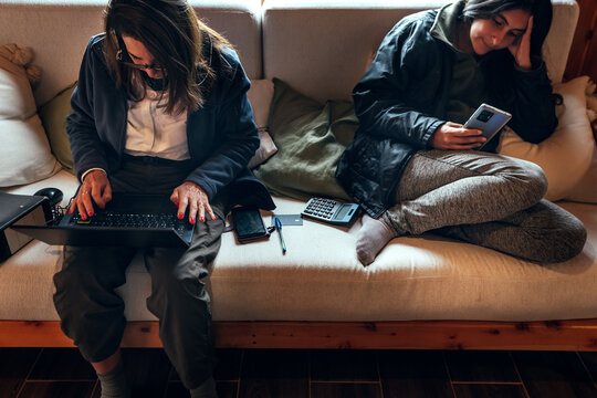 Mother With Daughter Laying On The Couch At Home.