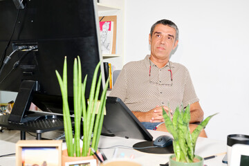 Content businessman at workplace.