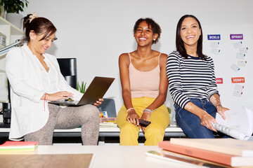 Relaxed businesswomen on desk.