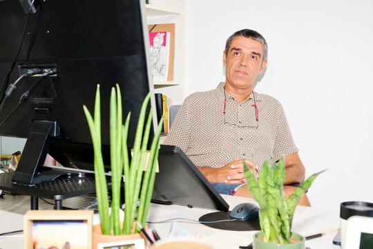 Content businessman at workplace.