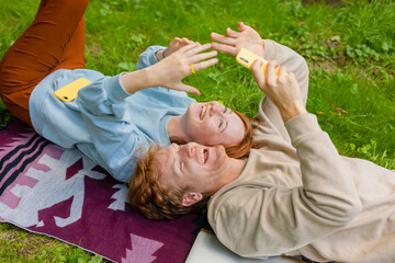happy couple taking a selfie at a picnic
