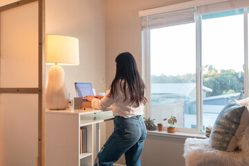 Woman at standing desk working remote from home