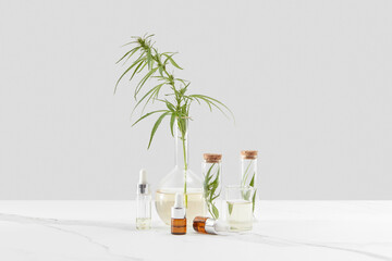 CBD oil bottles and glasses with green cannabis.
