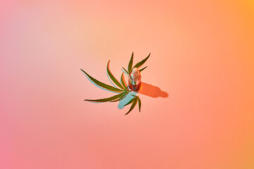 CBD oil bottle with cannabis natural leaves.