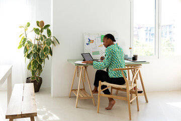 African woman working at bright office