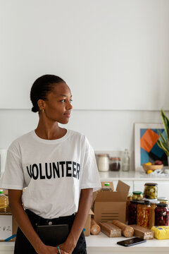 Pretty African volunteer in modern kitchen