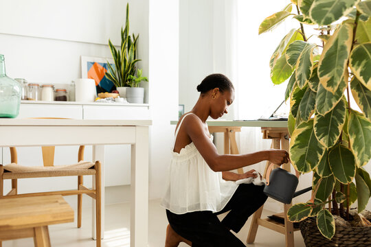 Woman watering plants at home