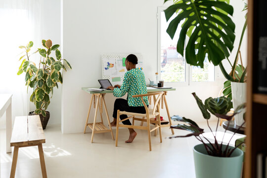 African woman working in her nice apartment