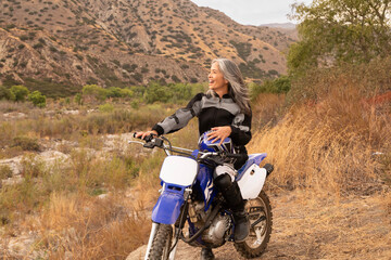 Mature woman outdoor on a dirtbike
