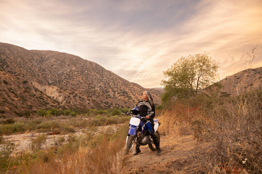 Mature woman outdoors on a motorcycle 