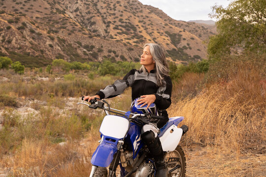 Mature Woman Outdoors On A Motor Cycle 