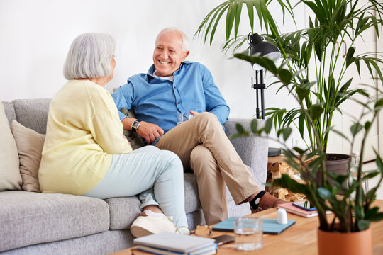 Elderly Couple Speaking In Living Room