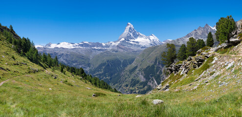 Fototapeta na wymiar The panorama of swiss walliser alps with the Matterhorn peak over the Mattertal valley and Zermatt.