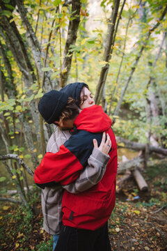 Couple hugging in autumn forest