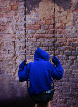 Lonely Child Alone on Swing 