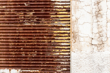 texture pattern of rusty iron door of closed store and white grunge wall in Brazil