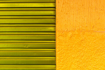 texture pattern of purpple iron door of closed store and yellow wall in Brazil