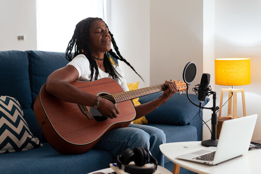 Old black lady Playing Guitar At Home 