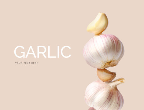 Creative layout made of garlic on the beige background. Flat lay. Food concept. Macro concept. 