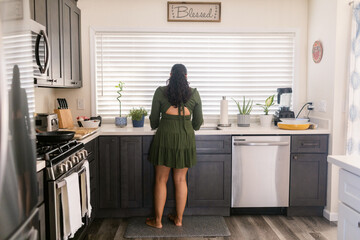Anonymous woman in the sink at kitchen