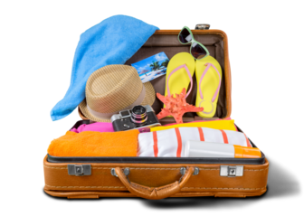 Retro suitcase with travel objects on wooden board on natural background
