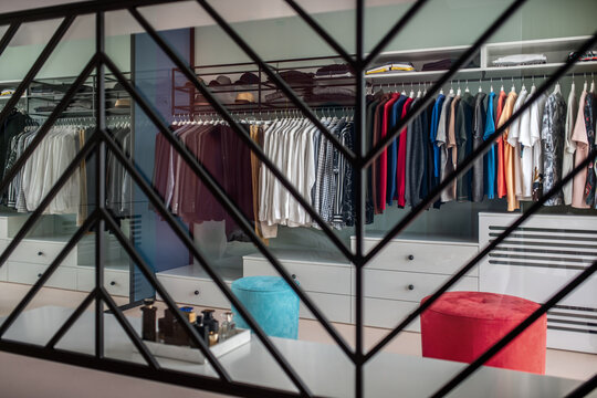 Big modern wardrobe with different clothes for dressing room