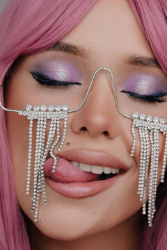 Pretty woman with make up licking crystals 