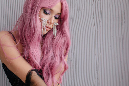 Beautiful woman with pink hair looking down