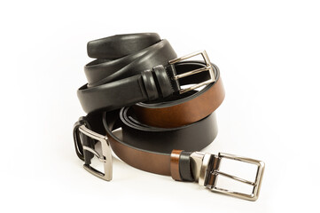 Fabric trousers and jeans genuine and faux leather black and brown belts isolated on white...
