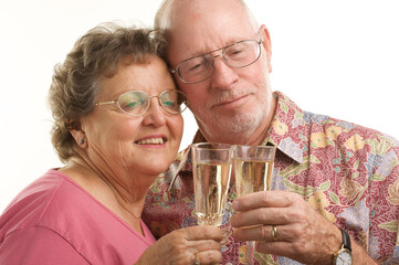 Happy Senior Couple Toasting with Champagne Glasses