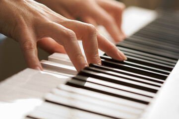 Obraz premium Woman's Fingers Playing on a Digital Piano Keys