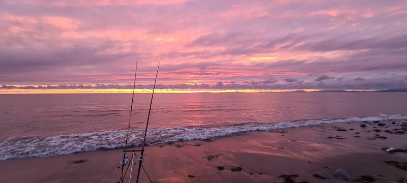 Beautiful pink twilight and sunset were seen on the horizon of the Fairbourne beach