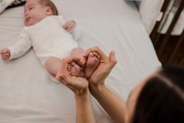 Mother holding baby feet