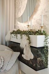 New Year's decorations. New Year's decorations. Fireplace with candlesticks. Luxury living room with a Christmas decor. Holiday background.