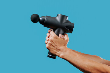 young man grabbing a massage gun