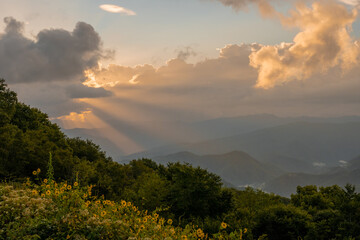 Fototapeta premium Shafts Of Light Burst Out From Behind.A Dark Cloud In The Blue Ridge Mountains