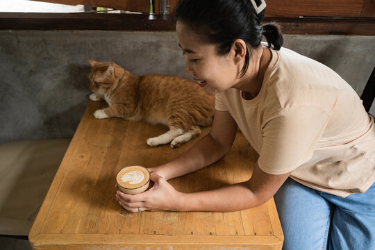Asian woman drinking latte 