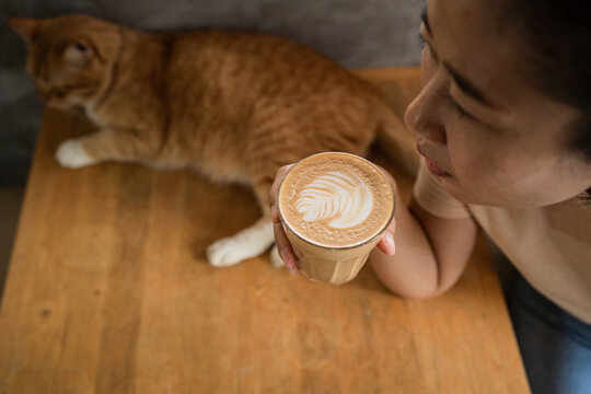 Asian woman drinking latte 