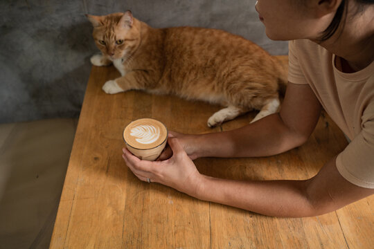Asian woman drinking latte 