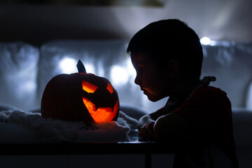 Kid decorating his house for the celebration of halloween
