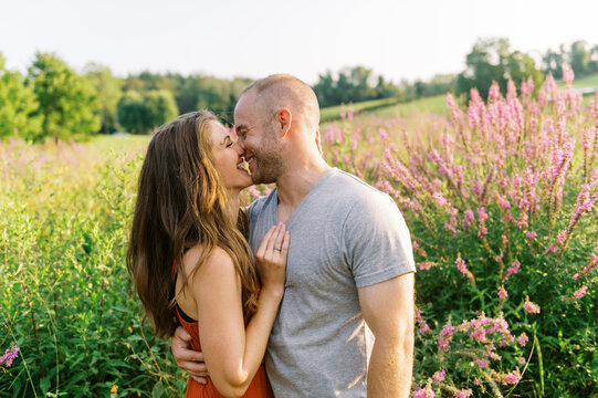 Happy married couple in field on a summer day