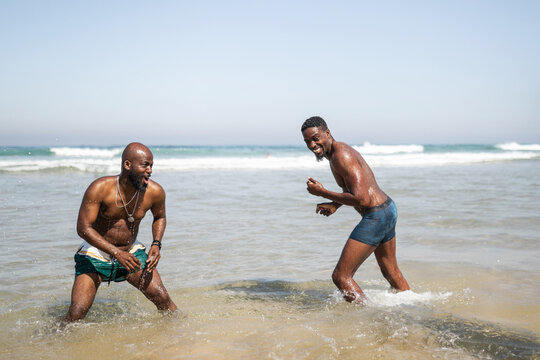 Young black men having fun in the sea