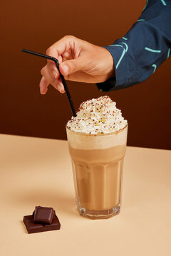 Crop woman enjoying frappe coffee