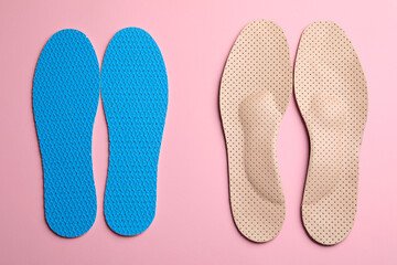 Pairs of breathable shoe insoles on pink background, flat lay