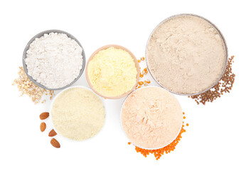 Different types of flour in bowls on white background, top view