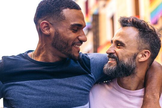 Multiracial Gay Couple In Love Looking Into Each Other's Eyes