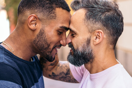 Multiracial gay couple in love looking into each other's eyes
